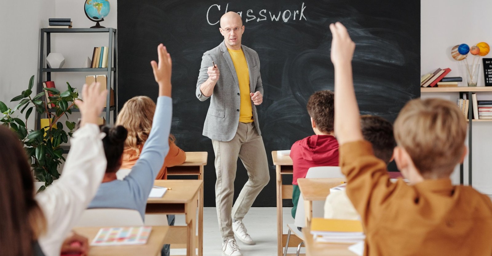 Teacher working with teenage English learners in a classroom